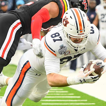Dec 30, 2023; Nashville, TN, USA;  Auburn Tigers tight end Brandon Frazier (87) and Maryland Terrapins defensive back Beau Brade (2) during the first half at Nissan Stadium. Mandatory Credit: Steve Roberts-Imagn Images