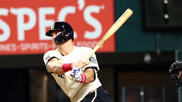 Texas Rangers third baseman Josh Jung (6) hits an rbi single while wearing a white uniform and black helmet