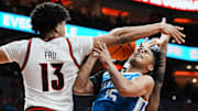 Louisville Cardinals forward Sananda Fru (13) pressured Kentucky Wildcats guard Jaland Lowe (15) during the Cards' win over the Cats 96-88 in the UofL-UK annual rivalry game at the KFC Yum! Center in Louisville, Kentucky Nov. 11, 2025.