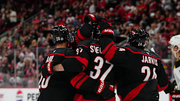 Oct 31, 2024; Raleigh, North Carolina, USA;  Carolina Hurricanes right wing Andrei Svechnikov (37) celebrates his goal with center Sebastian Aho (20) and center Seth Jarvis (24) during the first period against the Boston Bruins during the first period at Lenovo Center. Mandatory Credit: James Guillory-Imagn Images
