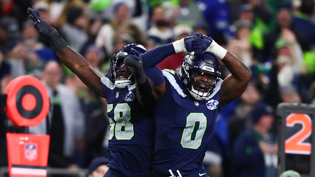 Jan 17, 2026; Seattle, WA, USA; Seattle Seahawks linebacker Derick Hall (58) and defensive end DeMarcus Lawrence (0) react after a strip sack of San Francisco 49ers quarterback Brock Purdy during the second half in an NFC Divisional Round game at Lumen Field.