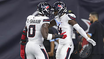 Houston Texans cornerback Kamari Lassiter celebrates with linebacker Azeez Al-Shaair.