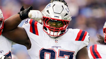 New England Patriots defensive end Milton Williams (97) celebrates sacking Tennessee Titans quarterback Cam Ward (1) during the third quarter at Nissan Stadium in Nashville, Tenn., Sunday, Oct. 19, 2025.