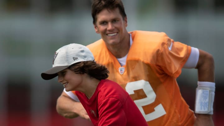 Tom Brady (12) chases his son Jack across the field during his time with the Tampa Bay Buccaneers.