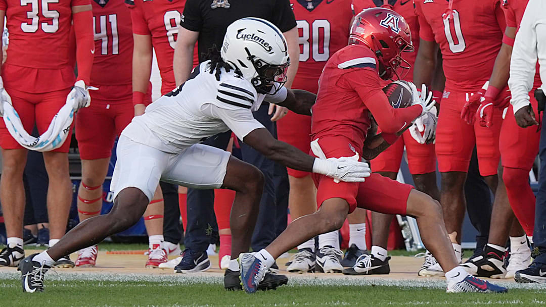 Arizona Wildcats wide receiver Kris Hutson (4) gets tackle by Iowa State Cyclones' defensive back Jontez Williams (3) after making a catch during the first quarter in the Big-12 conference showdown on Sept. 27, 2025, at Jack Trice Stadium in Ames, Iowa.