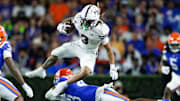 Mississippi State Bulldogs wide receiver Anthony Evans III (3) leaps over Florida Gators defensive back Alfonzo Allen Jr. (43) during the second half at Ben Hill Griffin Stadium. 