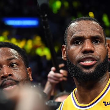 Dec 10, 2018; Los Angeles, CA, USA; Miami Heat guard Dwyane Wade (3) and Los Angeles Lakers forward LeBron James (23) are swarmed by media after the game at Staples Center. Mandatory Credit: Jayne Kamin-Oncea-Imagn Images