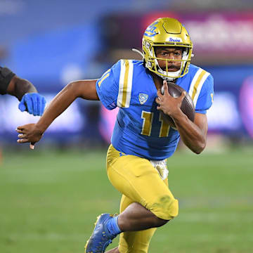 Dec 19, 2020; Pasadena, California, USA; UCLA Bruins quarterback Chase Griffin (11) runs the ball during overtime against the Stanford Cardinal at the Rose Bowl. Mandatory Credit: Jayne Kamin-Oncea-Imagn Images