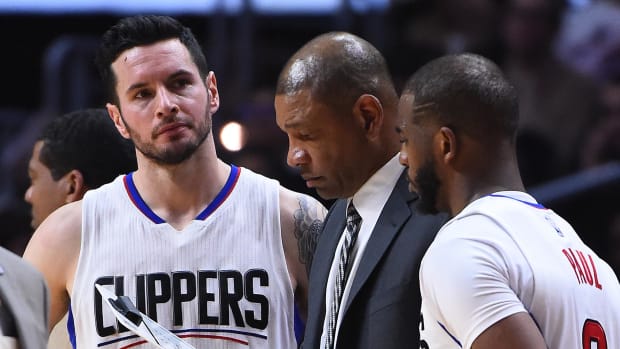 Feb 26, 2017; Los Angeles, CA, USA; Los Angeles Clippers head coach Doc Rivers talks with guard J.J. Redick (4) and guard Chris Paul (3) during a time out in the second half of the game against the Charlotte Hornets at Staples Center. Clippers won in OT 124-121. Mandatory Credit: Jayne Kamin-Oncea-USA TODAY Sports