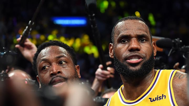 Dec 10, 2018; Los Angeles, CA, USA; Miami Heat guard Dwyane Wade (3) and Los Angeles Lakers forward LeBron James (23) are swarmed by media after the game at Staples Center. Mandatory Credit: Jayne Kamin-Oncea-Imagn Images