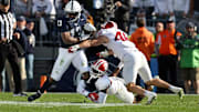 Nov 8, 2025; University Park, Pennsylvania, USA; Penn State Nittany Lions running back Kaytron Allen (13) runs with the ball while trying to avoid a tackle from Indiana Hoosiers defensive back Jamari Sharpe (22) during the second quarter at Beaver Stadium. Mandatory Credit: Matthew O'Haren-Imagn Images