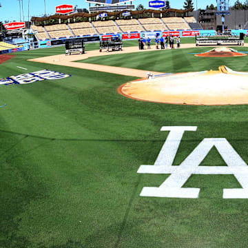 Oct 23, 2017; Los Angeles, CA, USA; Workers put finishing touches on the World Series logo and the field before today's workouts one day prior to game one of the World Series between the Los Angeles Dodgers and the Houston Astros at Dodger Stadium. Mandatory Credit: Jayne Kamin-Oncea-Imagn Images