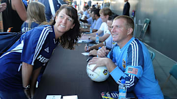 Aug 17, 2013; Carson, CA, USA;  Los Angeles Galaxy former goalkeeper Kevin Hartman signs an autograph for Nancy Norton before the game against Real Salt Lake at the Stubhub Center. Mandatory Credit: Jayne Kamin-Oncea-Imagn Images
