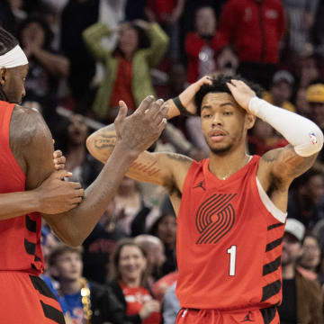 Jan 24, 2024; Houston, Texas, USA; Portland Trail Blazers forward Jabari Walker (34) and guard Anfernee Simons (1) celebrate with forward Jerami Grant (9) after he made a  three point basket in the fourth quarter to send the game into overtime against the Houston Rockets at Toyota Center. Mandatory Credit: Thomas Shea-USA TODAY Sports