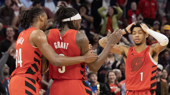 Jan 24, 2024; Houston, Texas, USA; Portland Trail Blazers forward Jabari Walker (34) and guard Anfernee Simons (1) celebrate with forward Jerami Grant (9) after he made a  three point basket in the fourth quarter to send the game into overtime against the Houston Rockets at Toyota Center. Mandatory Credit: Thomas Shea-USA TODAY Sports