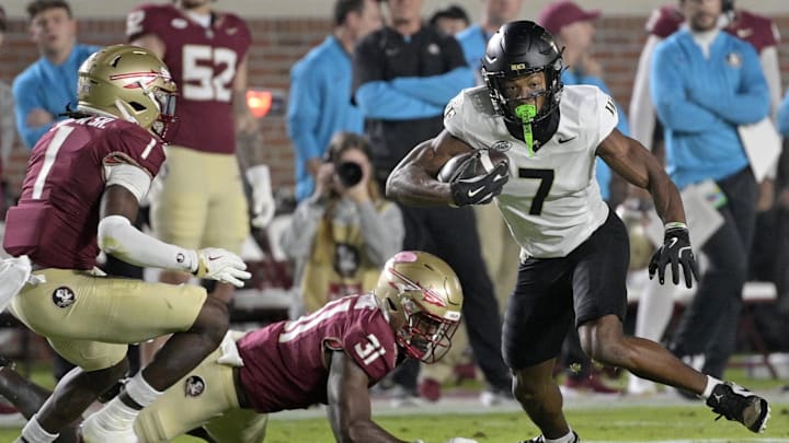 Nov 1, 2025; Tallahassee, Florida, USA; Wake Forest Demon Deacons wide receiver Micah Mays Jr. (7) runs with the ball past Florida State Seminoles linebacker Elijah Herring (31) and defensive back Shyheim Brown (1) during the first quarter at Doak S. Campbell Stadium. Mandatory Credit: Melina Myers-Imagn Images Nov 1, 2025; Tallahassee, Florida, USA; Wake Forest Demon Deacons wide receiver Micah Mays Jr. (7) runs with the ball past Florida State Seminoles linebacker Elijah Herring (31) and defensive back Shyheim Brown (1) during the first quarter at Doak S. Campbell Stadium. Mandatory Credit: Melina Myers-Imagn Images