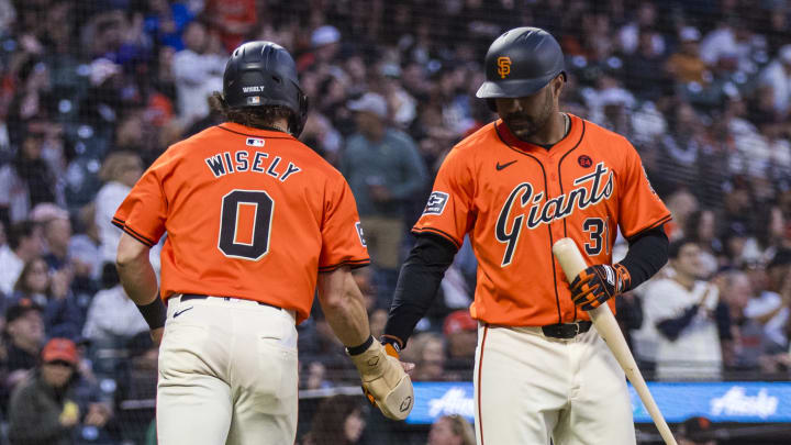 Jul 12, 2024; San Francisco, California, USA; San Francisco Giants shortstop Brett Wisely (0) is congratulated by San Francisco Giants first baseman LaMonte Wade Jr. (31) after he scored against the Minnesota Twins during the fifth inning at Oracle Park. 