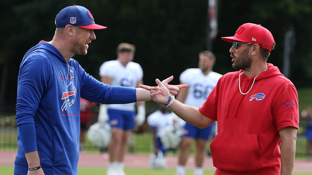 Bills offensive coordinator Joe Brady, left, and defensive coordinator Bobby Babich talk before the start of the final training camp session.