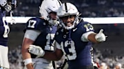  Penn State Nittany Lions running back Kaytron Allen (13) celebrates with quarterback Ethan Grunkemeyer after scoring a touchdown during the fourth quarter against the Nebraska Cornhuskers at Beaver Stadium. 