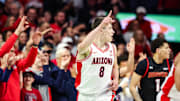 Nov 24, 2025; Tucson, Arizona, USA; Arizona Wildcats forward Ivan Kharchenkov (8) points after me makes a three pointer during the first half of the game against the Denver Pioneers at McKale Memorial Center. Mandatory Credit: Aryanna Frank-Imagn Images