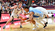 Mar 4, 2025; North Carolina guard Elliot Cadeau (3), Virginia Tech guard Jaden Schutt (2) and forward Ben Burnham (13) go after a loose ball.