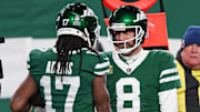 Jan 5, 2025; East Rutherford, New Jersey, USA; New York Jets quarterback Aaron Rodgers (8) and wide receiver Davante Adams (17) celebrates after a touchdown during the second half against the Miami Dolphins at MetLife Stadium. Mandatory Credit: Vincent Carchietta-Imagn Images