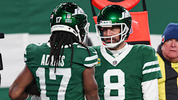 Jan 5, 2025; East Rutherford, New Jersey, USA; New York Jets quarterback Aaron Rodgers (8) and wide receiver Davante Adams (17) celebrates after a touchdown during the second half against the Miami Dolphins at MetLife Stadium. Mandatory Credit: Vincent Carchietta-Imagn Images