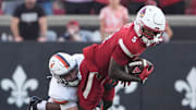 Louisville’s Caullin Lacy runs the ball against Virginia’s Ethan Minter at L&N Stadium Saturday.
Oct. 4, 2025