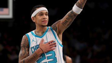 Nov 19, 2024; Brooklyn, New York, USA; Charlotte Hornets guard Tre Mann (23) reacts after receiving a technical foul during the third quarter against the Brooklyn Nets at Barclays Center. Mandatory Credit: Brad Penner-Imagn Images