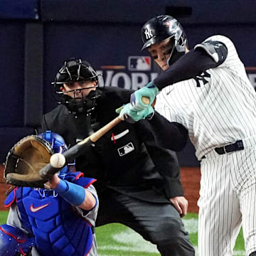 Oct 30, 2024; New York, New York, USA; New York Yankees outfielder Aaron Judge (99) hits a double during the eighth inning against the Los Angeles Dodgers in game four of the 2024 MLB World Series at Yankee Stadium.