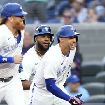 Jun 27, 2024; Toronto, Ontario, CAN; Toronto Blue Jays right fielder George Springer (right), designated hitter Justin Turner (2) and first baseman Vladimir Guerrero Jr. (center) celebrate at home plate after they scored on Springer's home run against the New York Yankees during the first inning at Rogers Centre. Mandatory Credit: John E. Sokolowski-USA TODAY Sports