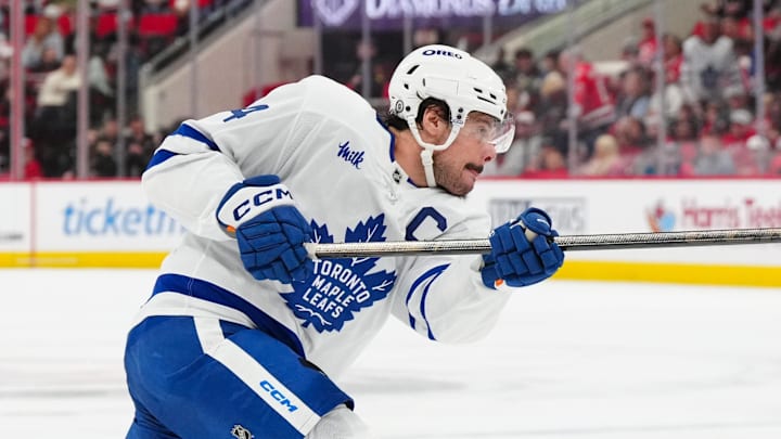Apr 13, 2025; Raleigh, North Carolina, USA;  Toronto Maple Leafs center Auston Matthews (34) takes a shot against the Carolina Hurricanes during the second period at Lenovo Center. Mandatory Credit: James Guillory-Imagn Images