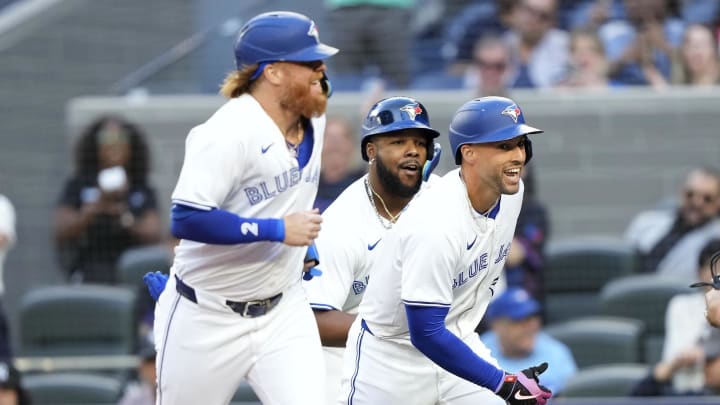 Jun 27, 2024; Toronto, Ontario, CAN; Toronto Blue Jays right fielder George Springer (right), designated hitter Justin Turner (2) and first baseman Vladimir Guerrero Jr. (center) celebrate at home plate after they scored on Springer's home run against the New York Yankees during the first inning at Rogers Centre. Mandatory Credit: John E. Sokolowski-USA TODAY Sports