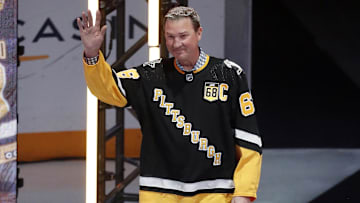 Feb 18, 2024; Pittsburgh, Pennsylvania, USA;  Pittsburgh Penguins former center Mario Lemieux waves to the crowd during a ceremony to retire the jersey number of Penguins former right wing Jaromir Jagr (not pictured) at PPG Paints Arena. The Penguins hosted the Los Angeles Kings after the ceremony. Los Angeles won 2-1. Mandatory Credit: Charles LeClaire-Imagn Images