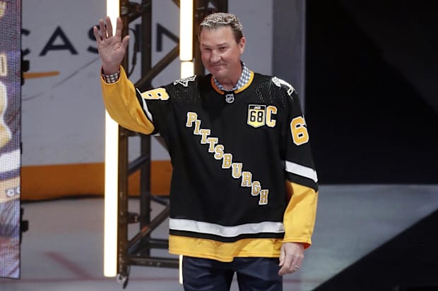 Hockey player waves to crow