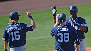 San Diego Padres right fielder Jabari Blash (32) slaps hands with San Diego Padres center fielder Travis Jankowski (16) and San Diego Padres starting pitcher Trevor Cahill (38) after hitting a grand slam against the Chicago Cubs during the fourth inning at Sloan Park on March 26, 2017.