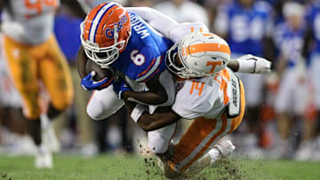 Tennessee defensive back Christian Charles (14) tackles Florida running back Nay'Quan Wright (6)  during the first quarter of an NCAA football game against Florida at Ben Hill Griffin Stadium in Gainesville, Florida on Saturday, Sept. 25, 2021.

Tennflorida0925 0802