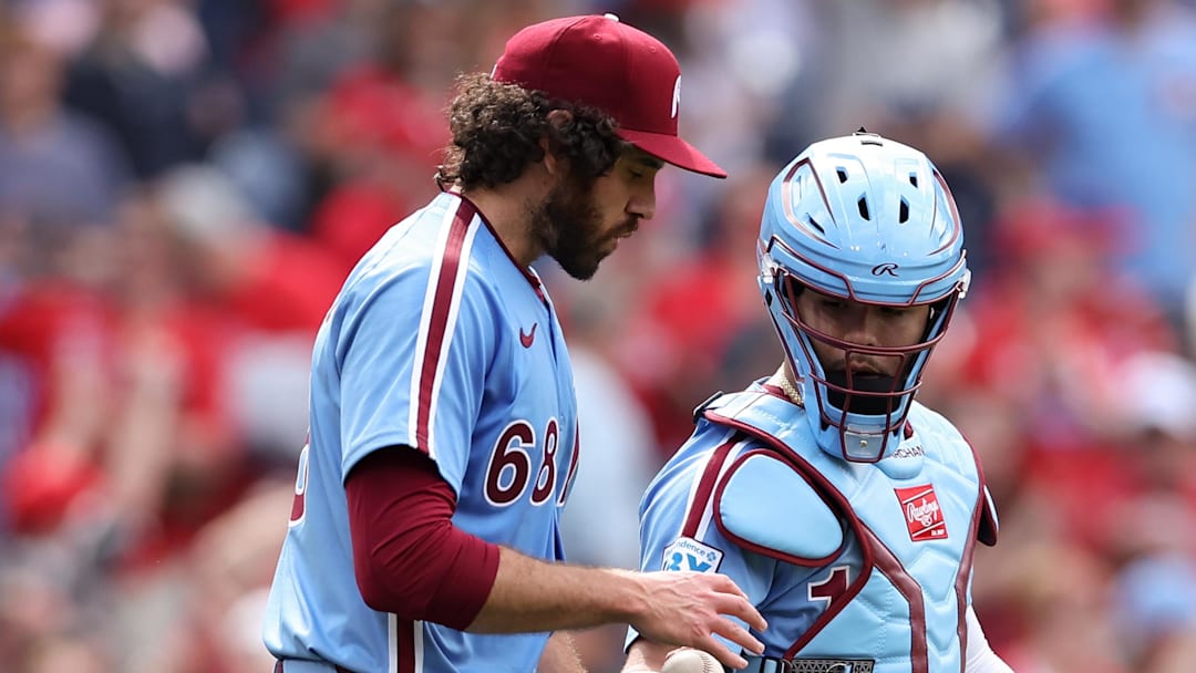 May 29, 2025; Philadelphia, Pennsylvania, USA; Philadelphia Phillies catcher Rafael Marchán (13) hands the game ball to pitcher Jordan Romano (68) after a victory against the Atlanta Braves at Citizens Bank Park. 