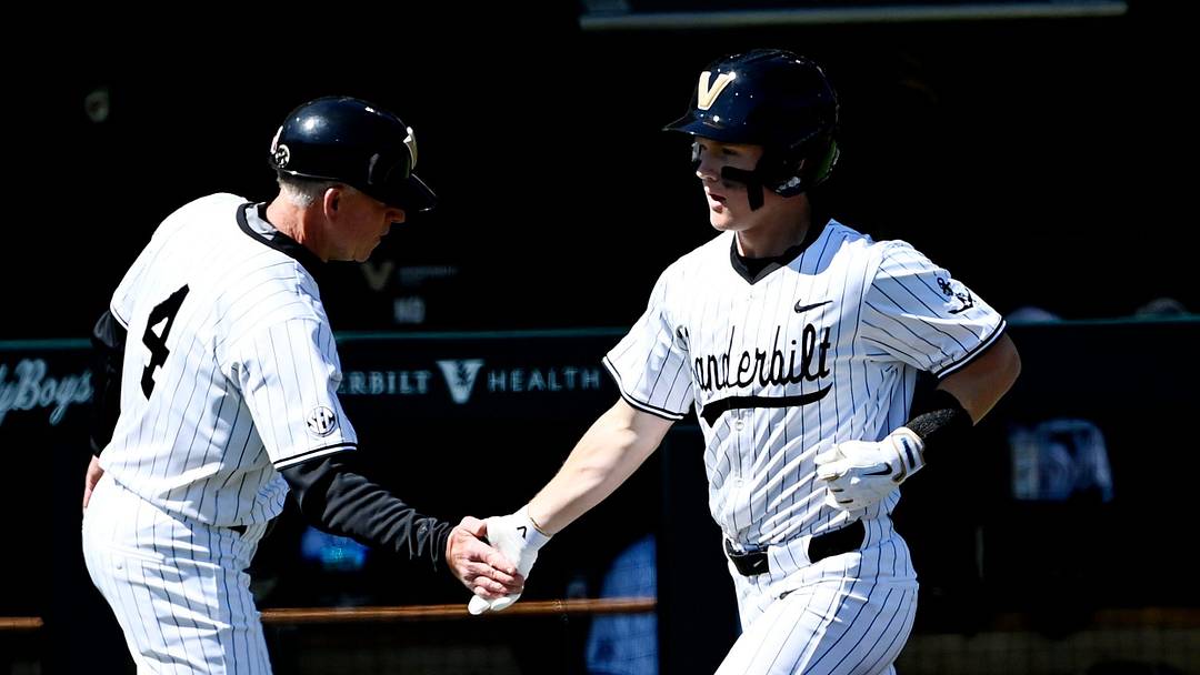 Vanderbilt's Ryker Waite (51) is congratulated by coach Tim Corbin after hitting two-run home run during the fourth inning of a NCAA baseball game at Hawkins Field on Saturday, March 28, 2026, in Nashville, Tenn.