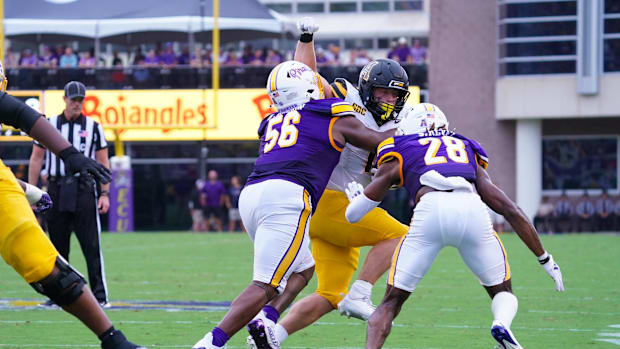 East Carolina Pirates defensive lineman D'Anta Johnson and defensive back Shavon Revel Jr. stops the run by Appalachian State