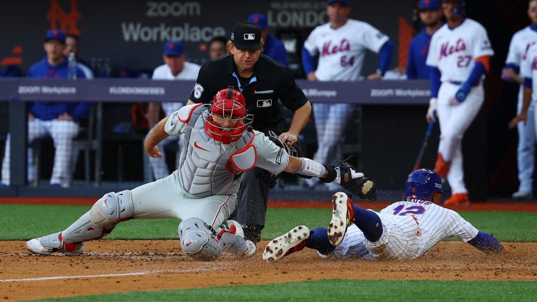 Francisco Lindor slides in safely to score a run