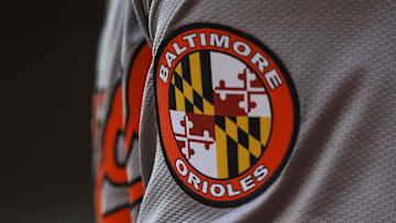 May 5, 2024; Cincinnati, Ohio, USA; The Baltimore Orioles logo on the sleeve of designated hitter Gunnar Henderson (2) as he prepares on deck during the seventh inning against the Cincinnati Reds at Great American Ball Park. Mandatory Credit: Katie Stratman-Imagn Images