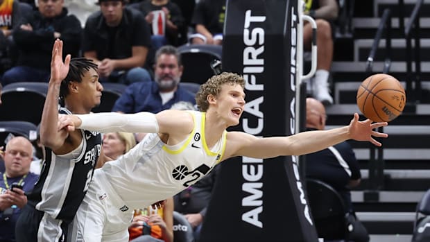 Utah Jazz forward Lauri Markkanen (23) reaches for a pass defended by San Antonio Spurs guard Devin Vassell
