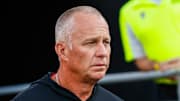Aug 28, 2025; Raleigh, North Carolina, USA; North Carolina State Wolfpack head coach Dave Doeren walks out during the warmups prior to the game against East Carolina Pirates at Carter-Finley Stadium. Mandatory Credit: Jaylynn Nash-Imagn Images