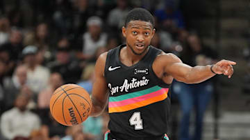 Nov 12, 2025; San Antonio, Texas, USA; San Antonio Spurs guard De'Aaron Fox (4) directs a play in the first half against the Golden State Warriors at Frost Bank Center.