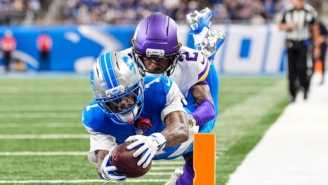 Detroit Lions wide receiver Jameson Williams (1) dives for a touchdown against Minnesota Vikings cornerback Isaiah Rodgers (2) during the second half at Ford Field in Detroit on Sunday, November 2, 2025.