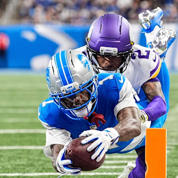 Detroit Lions wide receiver Jameson Williams (1) dives for a touchdown against Minnesota Vikings cornerback Isaiah Rodgers (2) during the second half at Ford Field in Detroit on Sunday, November 2, 2025.
