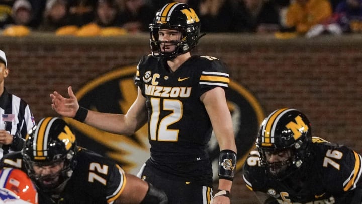 Nov 18, 2023; Columbia, Missouri, USA; Missouri Tigers quarterback Brady Cook (12) gestures at the line of scrimmage against the Florida Gators during the game at Faurot Field at Memorial Stadium. Mandatory Credit: Denny Medley-USA TODAY Sports