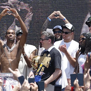 Jun 24, 2025; Oklahoma City, OK, USA; Oklahoma City Thunder guard Shai Gilgeous-Alexander, center, holds up a heart shape with his hands for fans during the Oklahoma City Thunder Champions parade. Center. Mandatory Credit: Alonzo Adams-Imagn Images