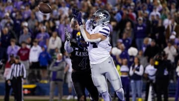 Nov 18, 2023; Lawrence, Kansas, USA; Kansas State Wildcats tight end Ben Sinnott (34) catches a touchdown pass against Kansas Jayhawks safety Marvin Grant (4) during the first half at David Booth Kansas Memorial Stadium. Mandatory Credit: Jay Biggerstaff-USA TODAY Sports